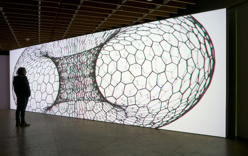 An allusion to biologism: in ‚We are all donuts', an oversized torus with an irregular organic honeycomb structure is set in rotation.