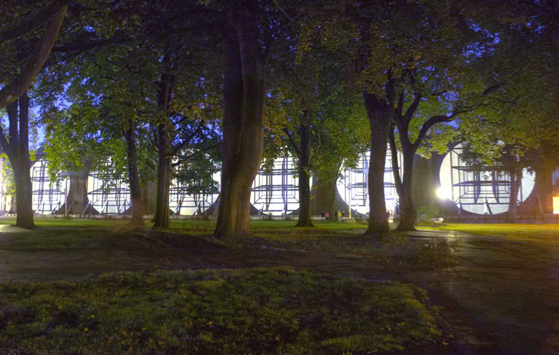 Opening of the lichtsicht5 projection biennial, Bad Rothenfelde. The 100-metre-wide projection onto the graduation tower can be seen through the trees.